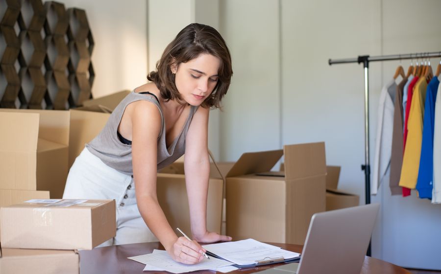 A self-employed small business owner working on a laptop in her home office